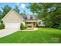 Charming home featuring a manicured lawn, two-car garage, and inviting front porch at 6530 Fly A Way Dr, Denver, NC 28037