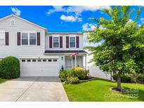 Charming two-story home with a well-maintained lawn and attached two-car garage at 8614 Westhope St, Charlotte, NC 28216