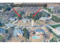 Aerial view of a flat one-acre lot in Fort Mill, featuring mature trees and beautiful surrounding homes at 908 Haddonfield Dr, Fort Mill, SC 29708