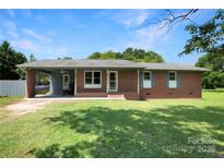 Charming single-story brick home featuring a covered carport, a well-maintained lawn, and lovely curb appeal at 1145 Craigbrow Cir, Chester, SC 29706
