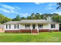 Charming single-story home with a welcoming front porch and well-manicured lawn at 118 Creek Hollow Trl, Belmont, NC 28012