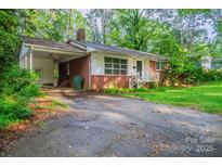 Charming brick home with a covered carport and a welcoming front porch at 1332 Midwood Dr, Gastonia, NC 28052