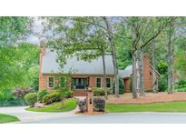 Charming brick home featuring a manicured lawn and lush landscaping at 2332 Hemby Pl, Charlotte, NC 28270