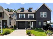 Modern two-story home featuring a front-entry garage and manicured lawn at 2600 Mason Cir # A, Charlotte, NC 28205
