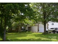 Charming home featuring well-manicured lawn, mature trees, and a welcoming front entrance at 3136 Blueberry Dr, Monroe, NC 28110