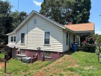 View of the home's side exterior with siding and an entry to the basement at 4059 10Th Avenue Sw Dr, Hickory, NC 28602