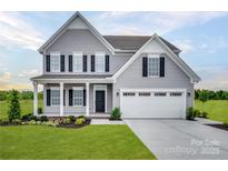 Charming two-story home with gray siding, black shutters, manicured lawn, and a two-car garage at 510 Lenswood Ct, Denver, NC 28037