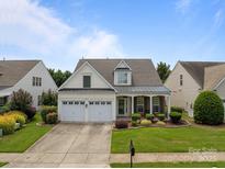 Charming home featuring a two-car garage, well-maintained lawn, and delightful landscaping at 5238 Prosperity View Dr, Charlotte, NC 28269