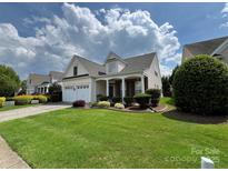Charming home with a well-manicured lawn, a two-car garage, and lovely landscaping at 5238 Prosperity View Dr, Charlotte, NC 28269