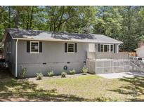 Charming home featuring a quaint front porch and gray exterior paint at 613 Davis St, Lancaster, SC 29720