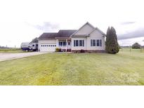 Charming single-story home with well-maintained lawn and attached two-car garage at 6825 Woodleaf Rd, Woodleaf, NC 27054