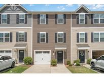 Townhome exterior with neutral siding, black shutters, a one-car garage, and well-maintained landscaping at 706 Dillon Way, Fort Mill, SC 29715