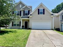 Charming two-story home with a two-car garage, well-maintained lawn, and classic architectural details at 712 Harrier Rd, Charlotte, NC 28216