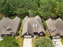 Beautiful aerial view of a brick home with a well-maintained roof and surrounded by lush greenery at 765 Cherry Hills Pl, Rock Hill, SC 29730