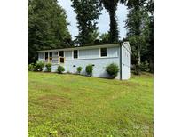 Charming single-story home featuring a combination of painted brick and siding and a well manicured front yard at 10514 Harbor Dr, Charlotte, NC 28214