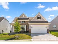 Charming two-story home with a two car garage, brick and siding exterior, landscaped yard, and inviting curb appeal at 125 White Apple Way, Statesville, NC 28625