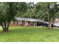 Charming single-story brick house with a well-manicured lawn and a covered carport on a beautiful lot at 148 Pratt Ln, Statesville, NC 28625
