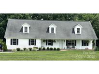 Charming single-story home with a welcoming porch, dormer windows, and black shutters at 247 Helton Rd, Cherryville, NC 28021