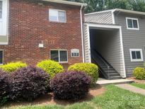 Brick and siding exterior showcasing the entryway and landscaping at 3200 Heathstead Pl # E, Charlotte, NC 28210