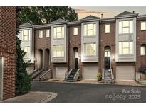 Beautiful brick townhomes with attached garages and landscaped front entrances at 333 W 7Th St, Charlotte, NC 28202
