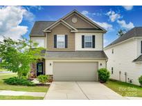 Charming two-story home featuring a two-car garage, landscaped yard, and mixed siding at 505 Silers Bald Dr, Fort Mill, SC 29715