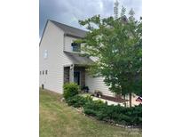 Charming two-story home featuring stone accents, a well-manicured lawn, and lovely landscaping at 505 Silers Bald Dr, Fort Mill, SC 29715