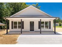 Charming single-story home with light siding, dark shutters, and a welcoming front porch at 812 Generation Ln, Clover, SC 29710