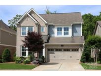 Charming two-story home featuring a brick facade, attached garage, and beautifully landscaped front yard at 914 Greenbridge Dr, Matthews, NC 28105
