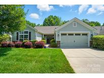 Charming single-Gathering home featuring a well-manicured lawn, attached two-car garage, and attractive landscaping at 9330 Carneros Creek Rd, Charlotte, NC 28214