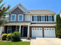 Inviting two-story home with a well-manicured lawn and a two-car garage with beautiful curb appeal at 11511 Wilson Mill Ln, Pineville, NC 28134