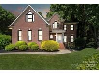 Charming two-story brick home with well-manicured lawn and mature landscaping at 121 Canterbury Xing, Fort Mill, SC 29708