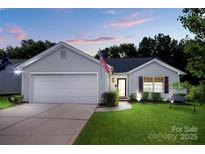 Charming single-story home with attached garage, manicured lawn, and lovely landscaping at 1288 Shenandoah Cir, Rock Hill, SC 29730