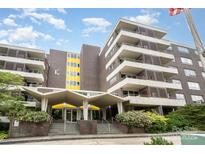 Modern brick condo building featuring balconies and a covered entrance at 1300 Reece Rd # 206, Charlotte, NC 28209