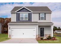 Charming two-story home with gray siding, a two-car garage, and a well-maintained lawn at 3315 Burberry Dr, Gastonia, NC 28052