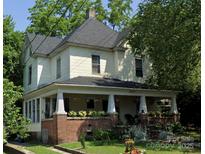 Charming two-story home with a welcoming front porch and a well-maintained lawn, perfect for relaxed outdoor living at 716 N Fulton St, Salisbury, NC 28144