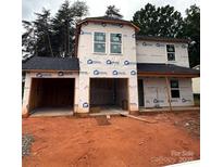 New two-story home under construction with a two-car garage and Barricade building wrap at 946 Wall St, Statesville, NC 28677