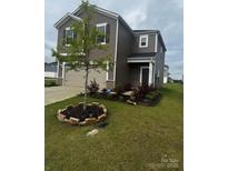 Charming two-story home features a landscaped front yard, attached two-car garage, and neutral color palette at 1022 Jeffery Dean Ct, Albemarle, NC 28001