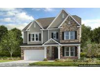 Charming two-story home with stone and siding exterior, a covered porch, and a two car garage at 1487 Hubert Graham Way, Tega Cay, SC 29708