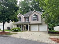 Charming two-story home features a two-car garage, landscaped yard, and classic architectural details at 19010 Oakhurst Blvd, Cornelius, NC 28031