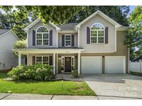 Charming two-story home with a well-manicured lawn, two-car garage, and inviting front porch at 19010 Oakhurst Blvd, Cornelius, NC 28031