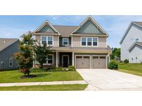 Charming two-story home featuring a two-car garage, well-manicured lawn, and inviting curb appeal at 2720 Watergarden St, York, SC 29745