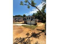 Charming two-story home with attached two-car garage and inviting curb appeal at 319 Conner St, Lancaster, SC 29720