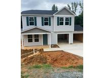 Charming two-story home with green shutters and a two-car garage in a suburban neighborhood at 323 Conner St, Lancaster, SC 29720