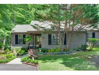 Charming single-story home featuring a well-manicured front yard with mature trees and lush landscaping at 353 Tall Oaks Trl, Fort Mill, SC 29715