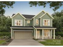 Charming two-story home featuring a two-car garage, covered porch, and a mix of siding and stone accents at 5116 Izzo Ln, Charlotte, NC 28214