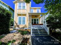 Charming yellow two-story home with a welcoming front porch and manicured landscaping at 751 Terrace Park, Rock Hill, SC 29730