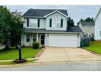 Charming two-story home with a well-manicured lawn and a two-car garage in a suburban neighborhood at 7918 Boars Head Ct, Charlotte, NC 28214