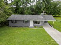 Charming one-story home with a well-maintained lawn and a covered carport at 102 Central Ave, Bessemer City, NC 28016
