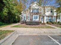 Charming townhome featuring stone accents, manicured landscaping, and a welcoming front entrance at 120 Prairie View Ct, Belmont, NC 28012