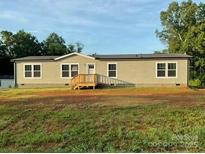 Charming single-story home featuring a covered porch and a well-maintained yard at 138 Zircon Dr, Statesville, NC 28625